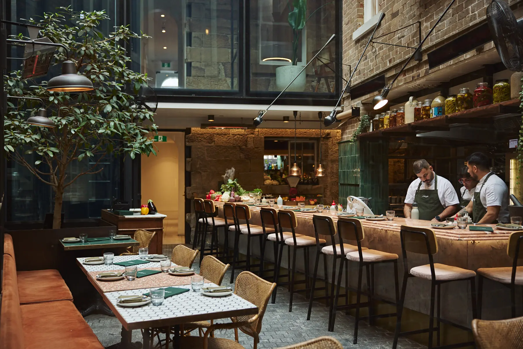 A vibrant Middle Eastern feast at Shaffa, featuring oysters, mezze, and fresh cocktails, served on a green-tiled table in Surry Hills.