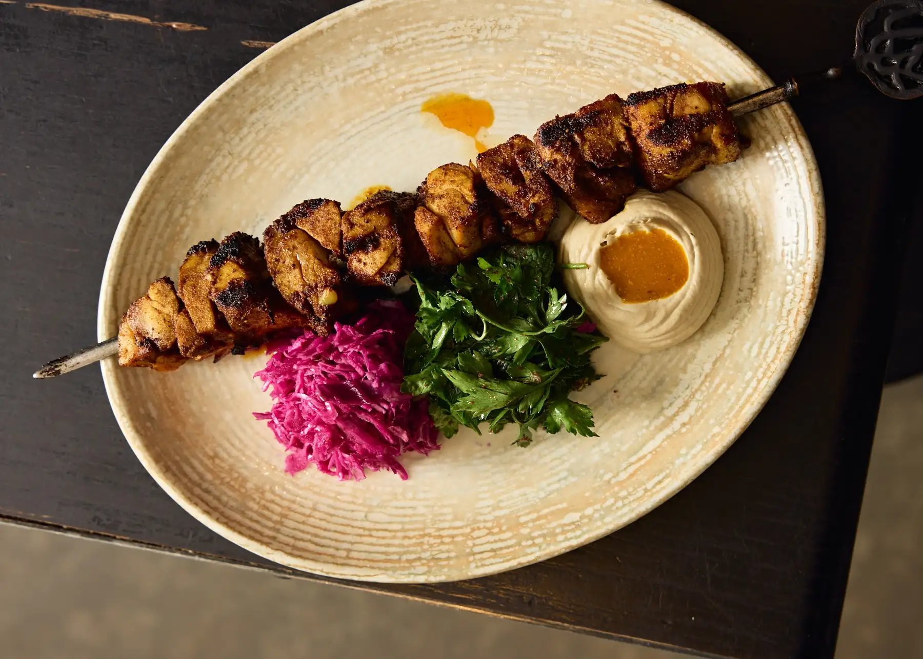A vibrant Middle Eastern feast at Shaffa, featuring oysters, mezze, and fresh cocktails, served on a green-tiled table in Surry Hills.